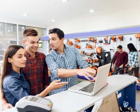 people at POS looking at laptop