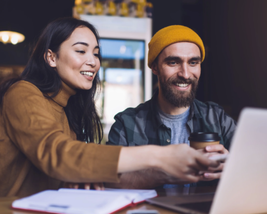 man and woman working on a laptop together